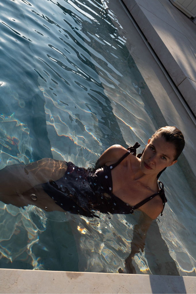 Model in pool wearing Florentine Swimsuit in Brown Spot
