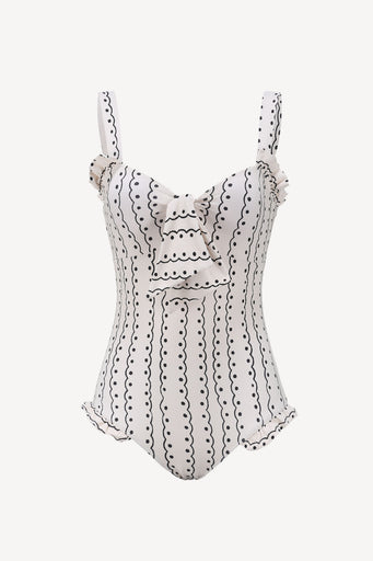 Ivory swimsuit with black scallop print on a white background