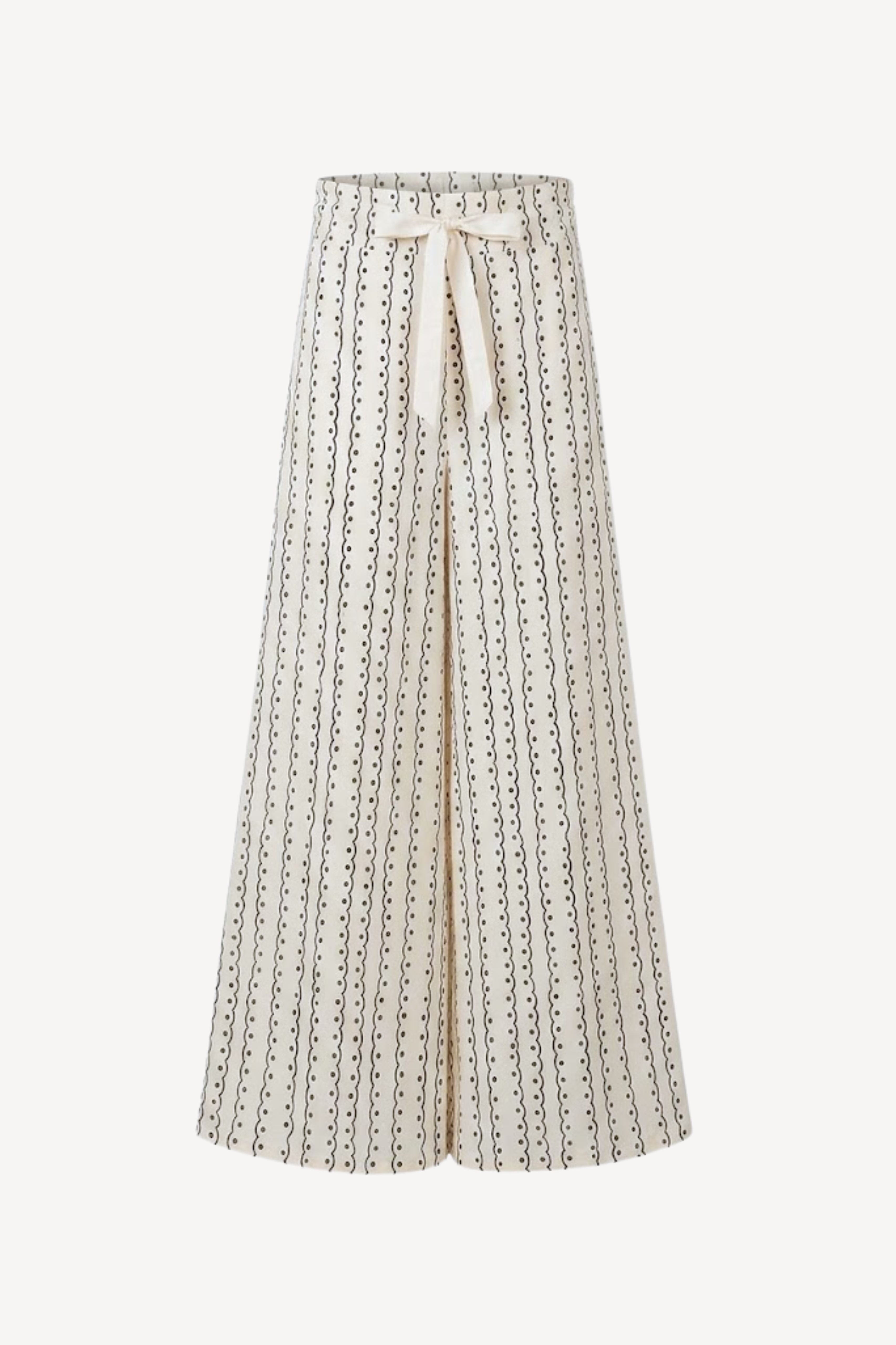 A high-waisted, wide-leg pleated skirt in cream with a black dotted vertical stripe pattern and a matching cream tie belt at the waist, shown against a plain light background.