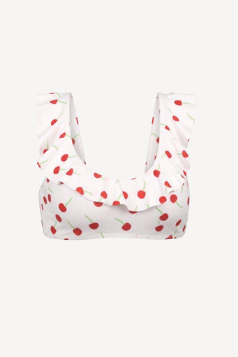White bikini top with red cherry pattern on a white background